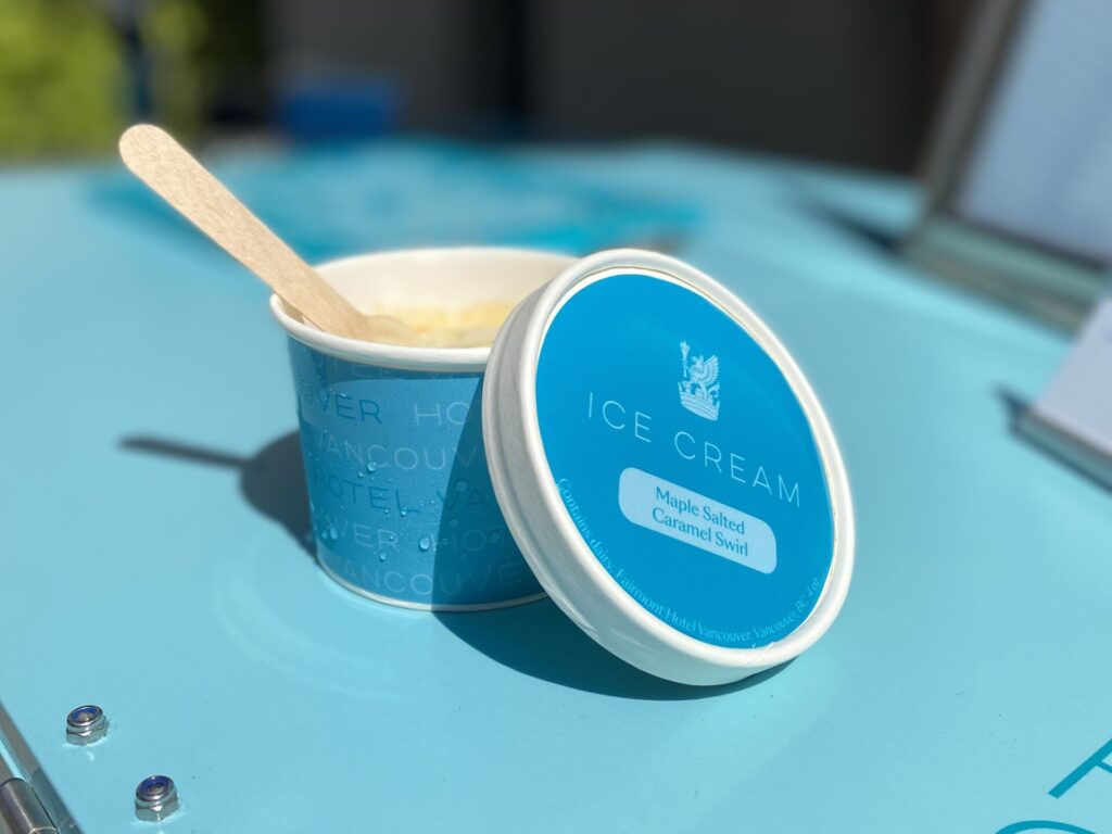 Small ice cream container with blue label and a wooden spoon