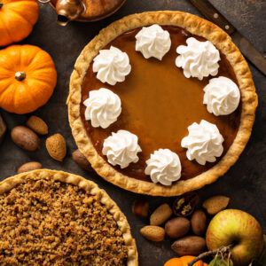 Pumpkin pie with an autumn background