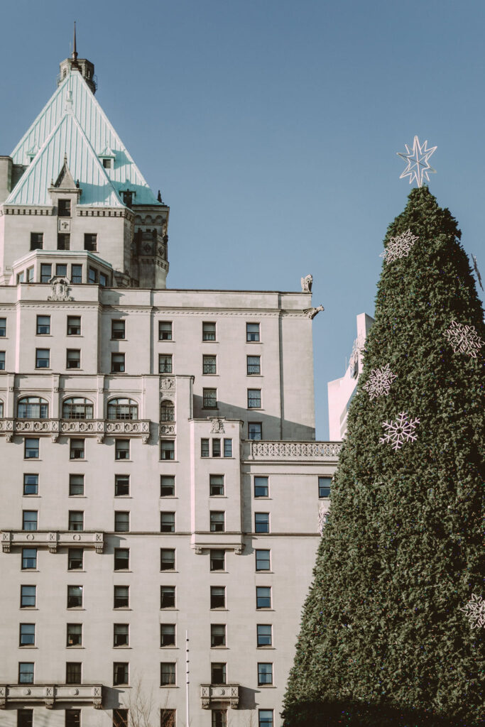 The City of Vancouver's Christmas tree with the exterior of Fairmont Hotel Vancouver in the background.