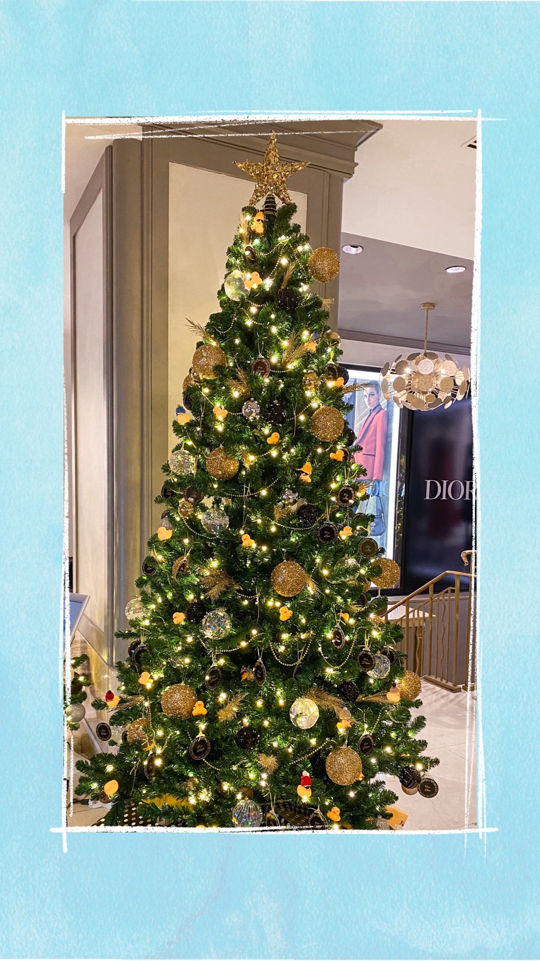 A holiday tree decorated with gold and silver ornaments for the BCCHF Festival of Trees