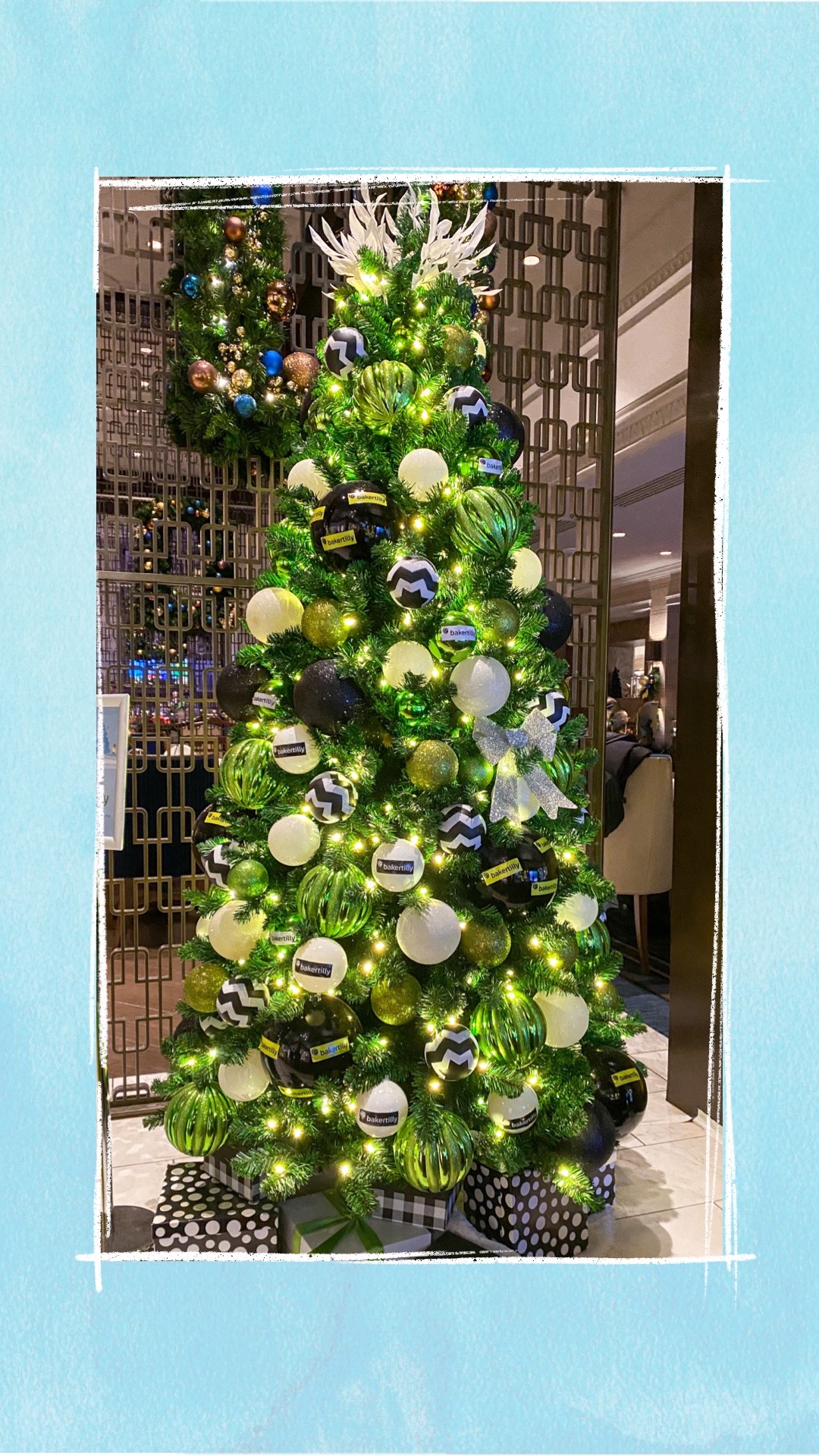 A holiday tree decorated with blue and white ornaments for the BCCHF Festival of Trees